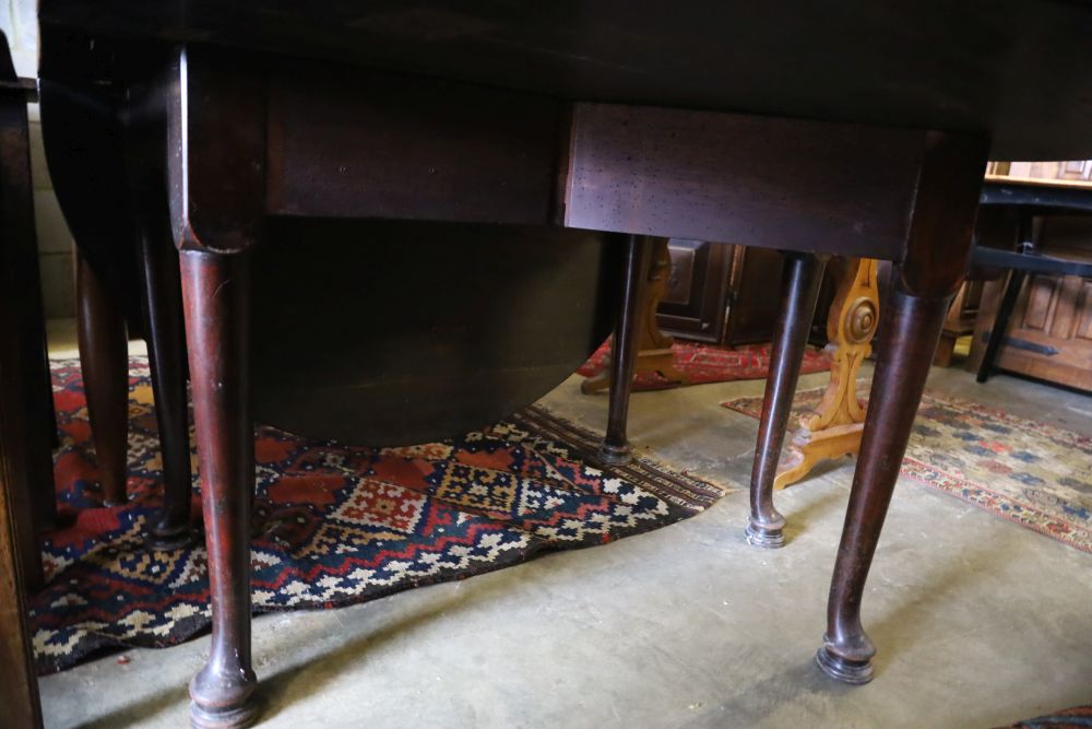 A George III mahogany pad foot oval drop leaf dining table, 170cm extended, width 120cm, height 74cm